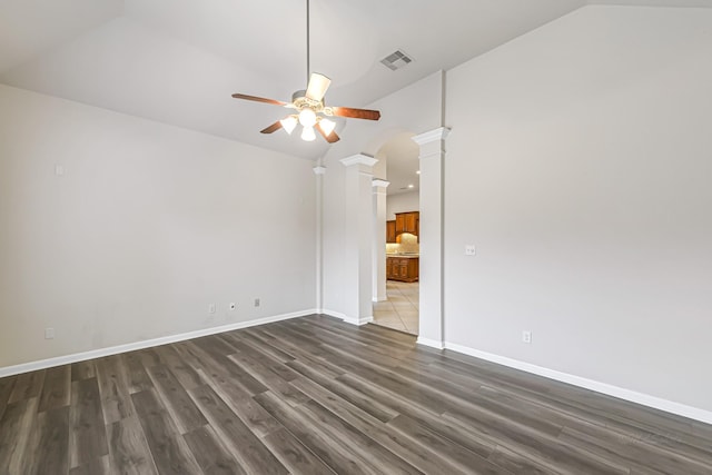 unfurnished room featuring dark hardwood / wood-style floors, ceiling fan, ornate columns, and vaulted ceiling