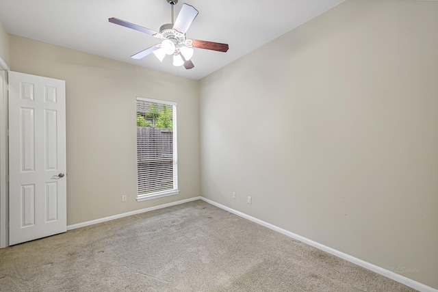 carpeted empty room featuring ceiling fan