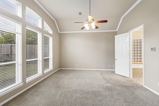 carpeted empty room featuring ceiling fan, lofted ceiling, and crown molding