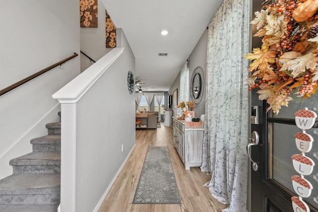 entrance foyer with ceiling fan and light hardwood / wood-style flooring