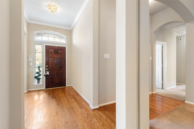 entrance foyer featuring light hardwood / wood-style floors and ornamental molding