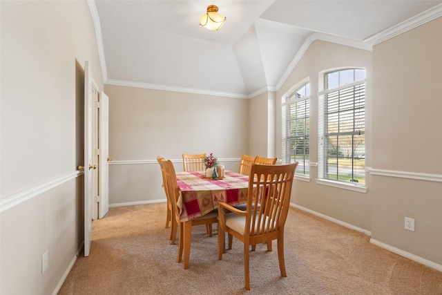 dining room with light carpet, crown molding, and vaulted ceiling