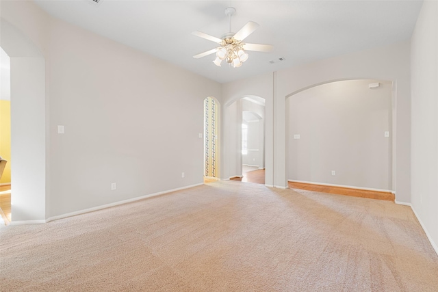 carpeted spare room with ceiling fan