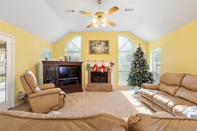 carpeted living room with ceiling fan, a fireplace, and vaulted ceiling