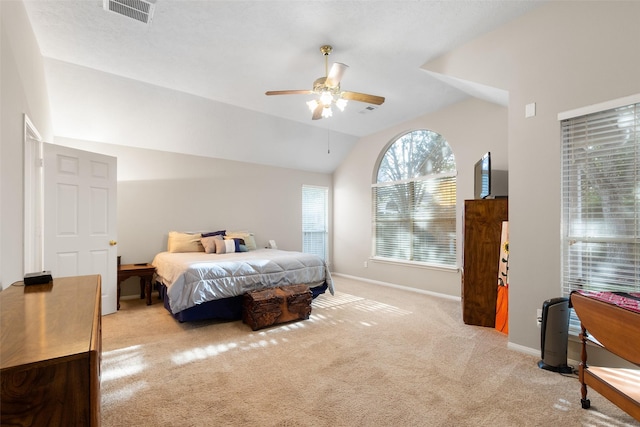 bedroom featuring light carpet, vaulted ceiling, and ceiling fan