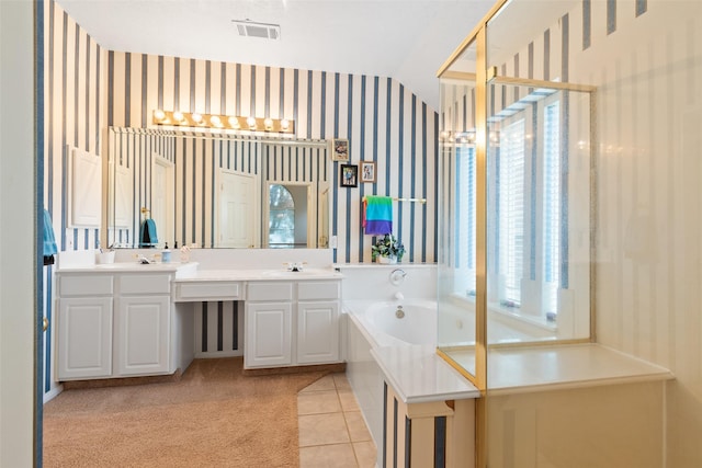 bathroom with tile patterned floors, vanity, a tub to relax in, and vaulted ceiling