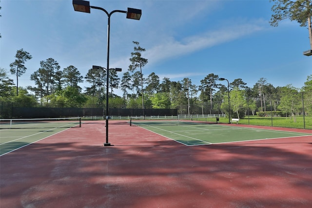 view of tennis court with basketball hoop