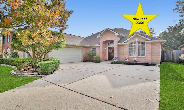 view of front of property with a garage and a front lawn