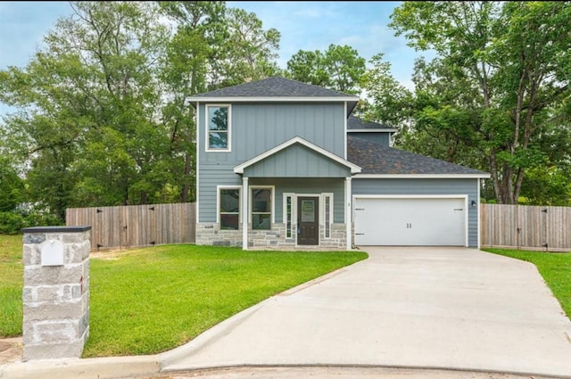 view of front of property with a front yard and a garage