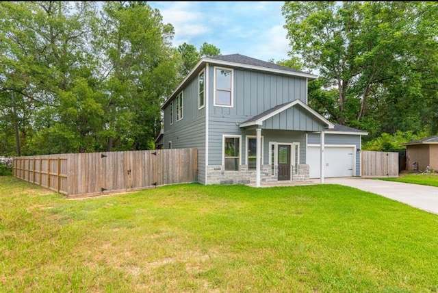 view of front of property with a garage and a front lawn