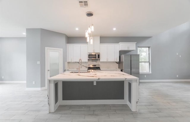 kitchen featuring stainless steel appliances, a spacious island, sink, white cabinetry, and hanging light fixtures