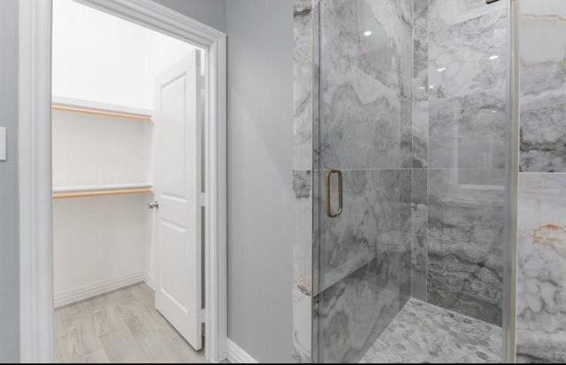 bathroom featuring hardwood / wood-style floors and a shower with shower door