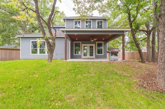 rear view of house featuring french doors, a yard, a patio, and ceiling fan