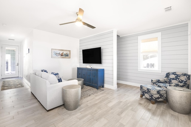 living room featuring ceiling fan and light wood-type flooring