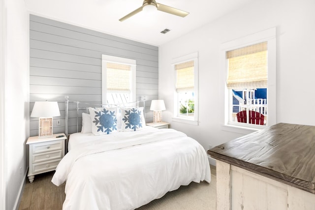 bedroom with ceiling fan and dark hardwood / wood-style floors