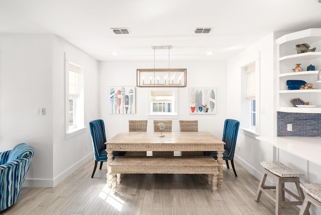 dining space featuring light wood finished floors, baseboards, visible vents, and recessed lighting
