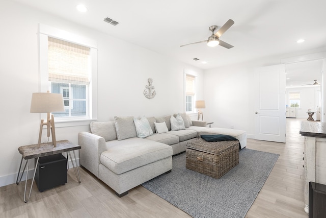 living room with wood-type flooring and ceiling fan