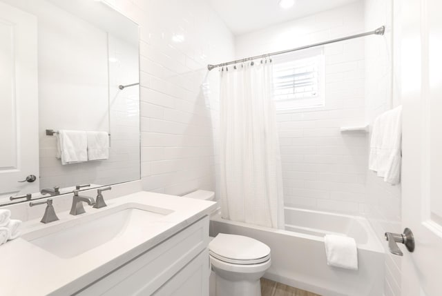 full bathroom featuring toilet, vanity, and shower / bathtub combination with curtain