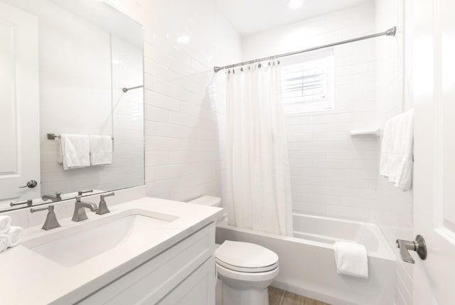 bathroom featuring toilet, shower / bathtub combination with curtain, and vanity