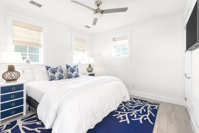 bedroom with ceiling fan and light wood-type flooring