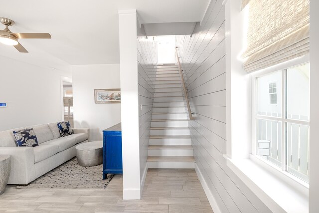 stairway featuring hardwood / wood-style floors and ceiling fan