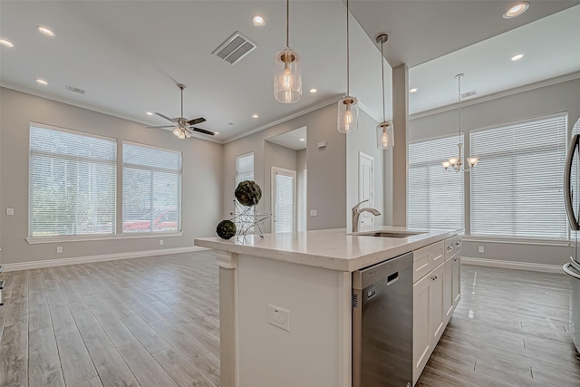 kitchen featuring white cabinetry, dishwasher, sink, decorative light fixtures, and a center island with sink