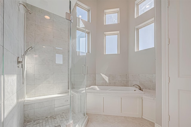 bathroom featuring tile patterned floors and independent shower and bath