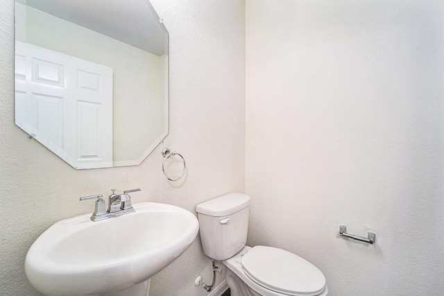 bathroom with toilet and sink