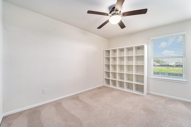 carpeted empty room with ceiling fan