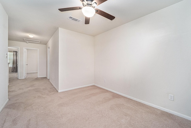 spare room with light carpet and ceiling fan