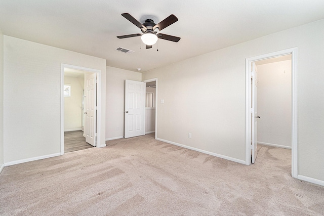 unfurnished bedroom with ceiling fan and light carpet