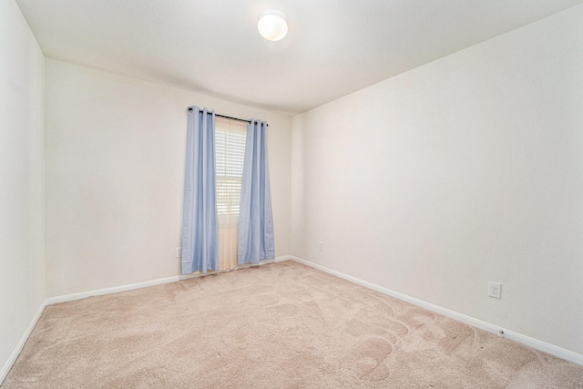 unfurnished room with light colored carpet