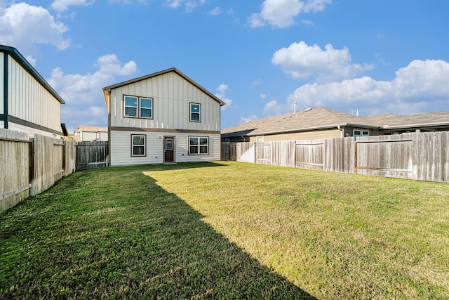 back of property featuring a yard