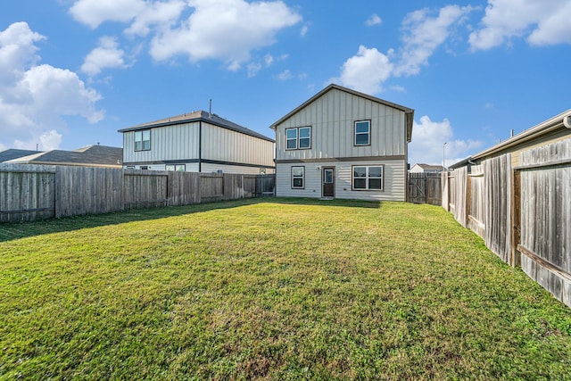 back of house with a lawn