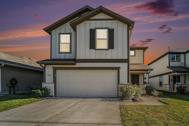 view of front of property with a garage and a lawn