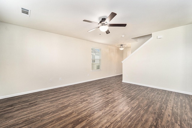 empty room with ceiling fan and dark hardwood / wood-style flooring