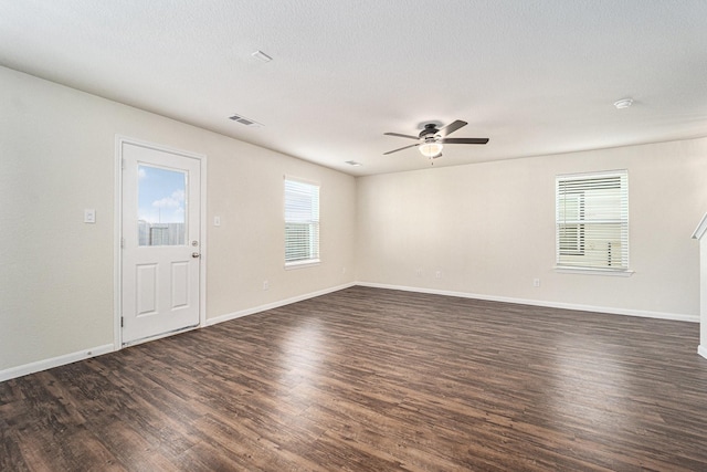 spare room featuring ceiling fan and dark hardwood / wood-style floors