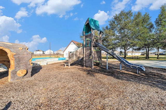 view of playground featuring a swimming pool