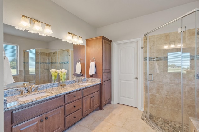 bathroom with tile patterned floors, vanity, and a shower with door