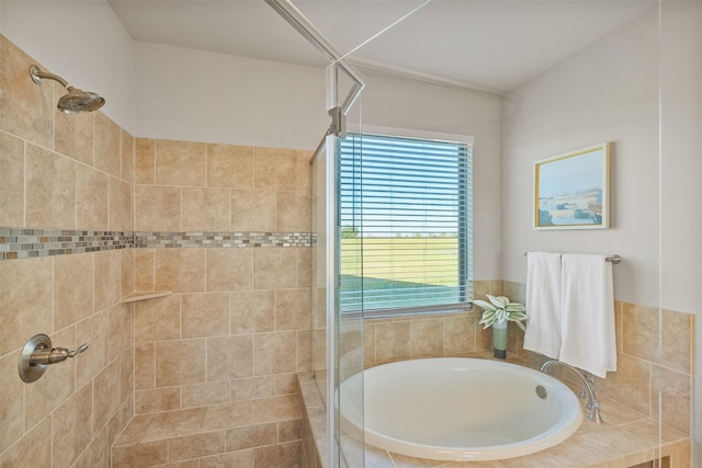 bathroom featuring independent shower and bath