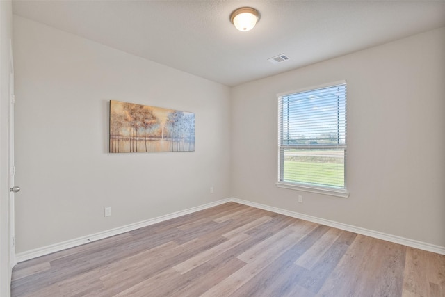 empty room with light hardwood / wood-style flooring