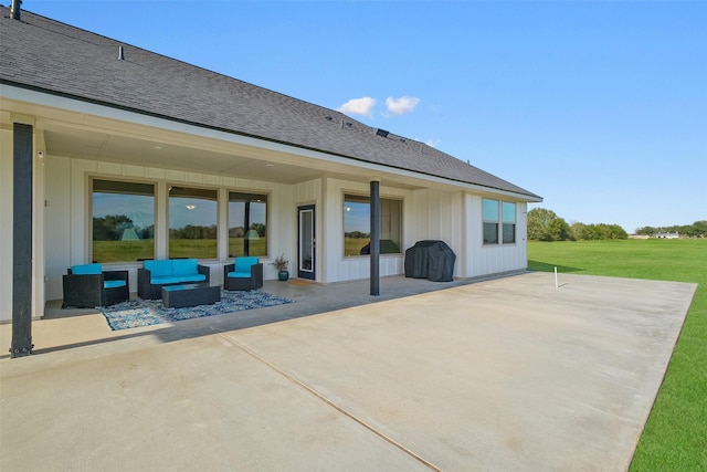 rear view of property featuring outdoor lounge area, a patio area, and a lawn