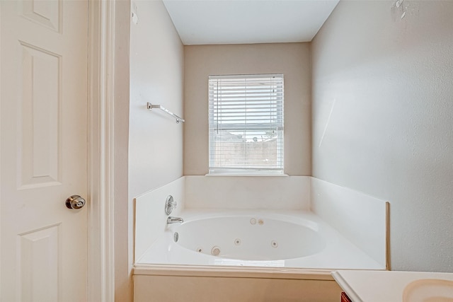 bathroom featuring vanity and a bath