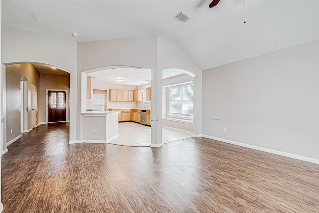 unfurnished living room featuring ceiling fan, light hardwood / wood-style floors, and lofted ceiling