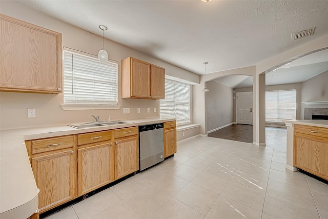 kitchen featuring dishwasher, light brown cabinets, decorative light fixtures, and sink