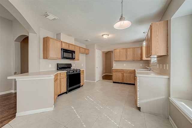 kitchen featuring light tile patterned floors, hanging light fixtures, light brown cabinetry, and black appliances