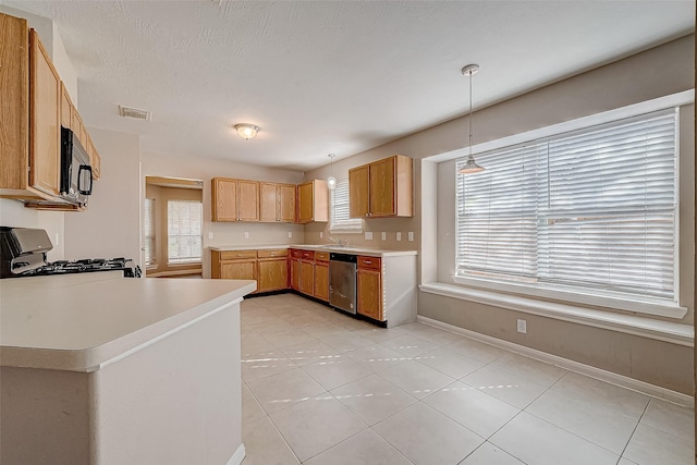 kitchen featuring dishwasher, hanging light fixtures, kitchen peninsula, light tile patterned floors, and range