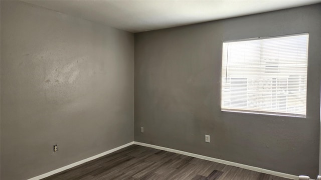 spare room featuring dark hardwood / wood-style floors