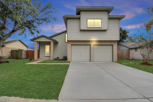 view of front of property featuring a lawn and a garage