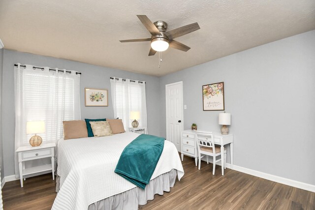 bedroom featuring a textured ceiling, ceiling fan, and dark hardwood / wood-style floors